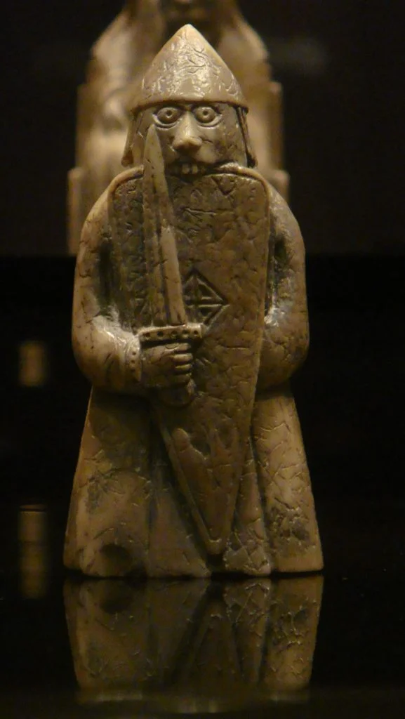 Four of the warder pieces are depicted as berserkers — Norse warriors biting their shields in battle frenzy, wild-eyed, in a state beyond fear