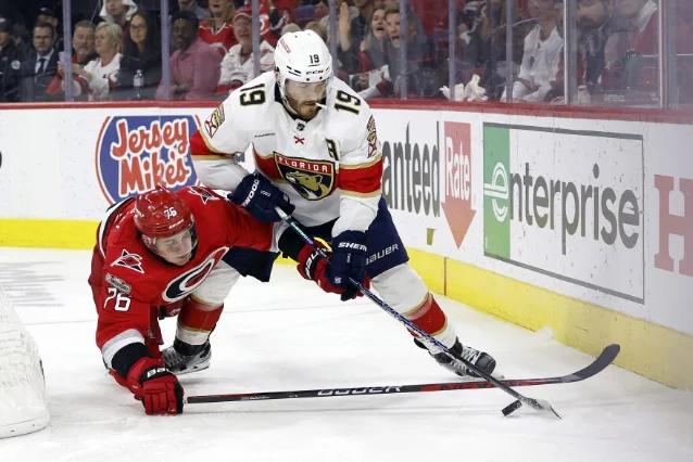 Matthew Tkachuk (19, white) protecting the puck against Brady Skjei (76, red) in the fourth overtime at PNC Arena