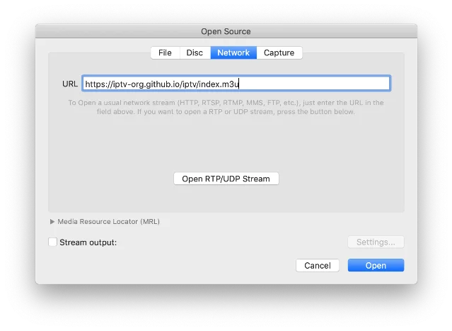 VLC "Open Source" dialog showing the iptv-org M3U URL entered in the Network tab, ready to load channels
