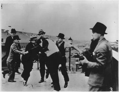 Richard Frankensteen being beaten by Ford Service Department men on the Miller Road overpass, May 26, 1937
