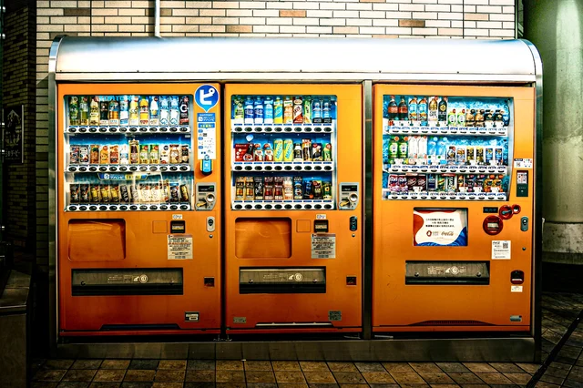 Three fully stocked vending machines side by side — each machine on a good route clears $400–$2,200/month net