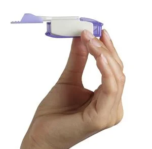 A child holds an Afrezza inhaler — the blue device fits in the palm and delivers a dose of insulin with a single breath