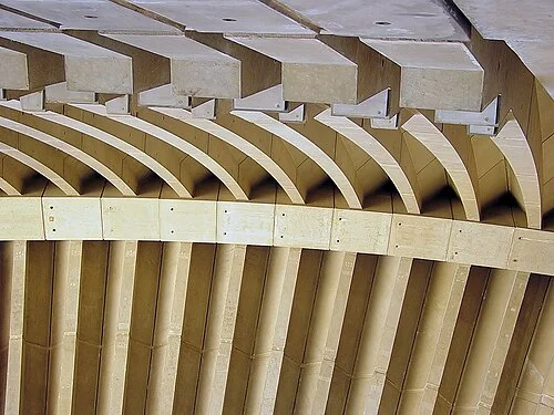 Precast concrete rib segments showing the repeating spherical arch geometry — pairs of parallel curved ribs separated by transverse spacers