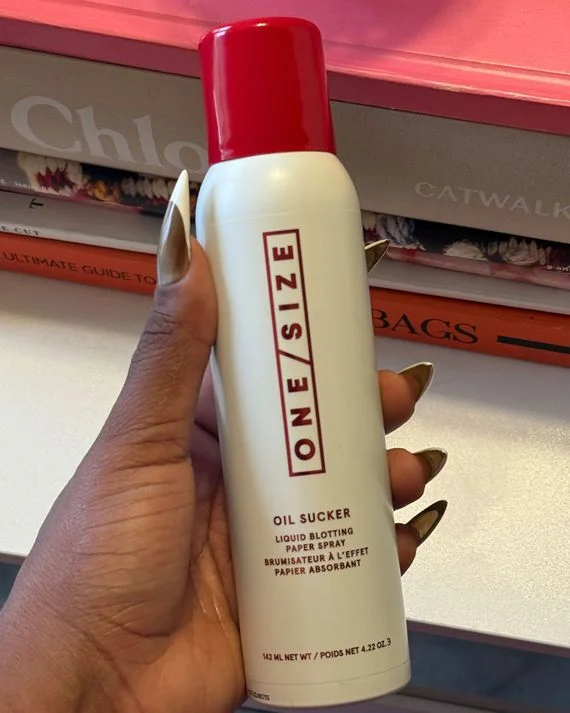 ONE/SIZE Oil Sucker Liquid Blotting Paper Spray full-size 142 mL white aerosol can with red cap, held in hand