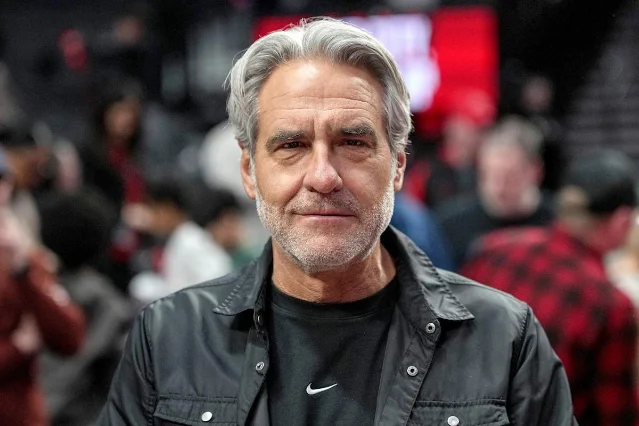 Nike CEO Elliott Hill at a public event wearing a Nike swoosh jacket