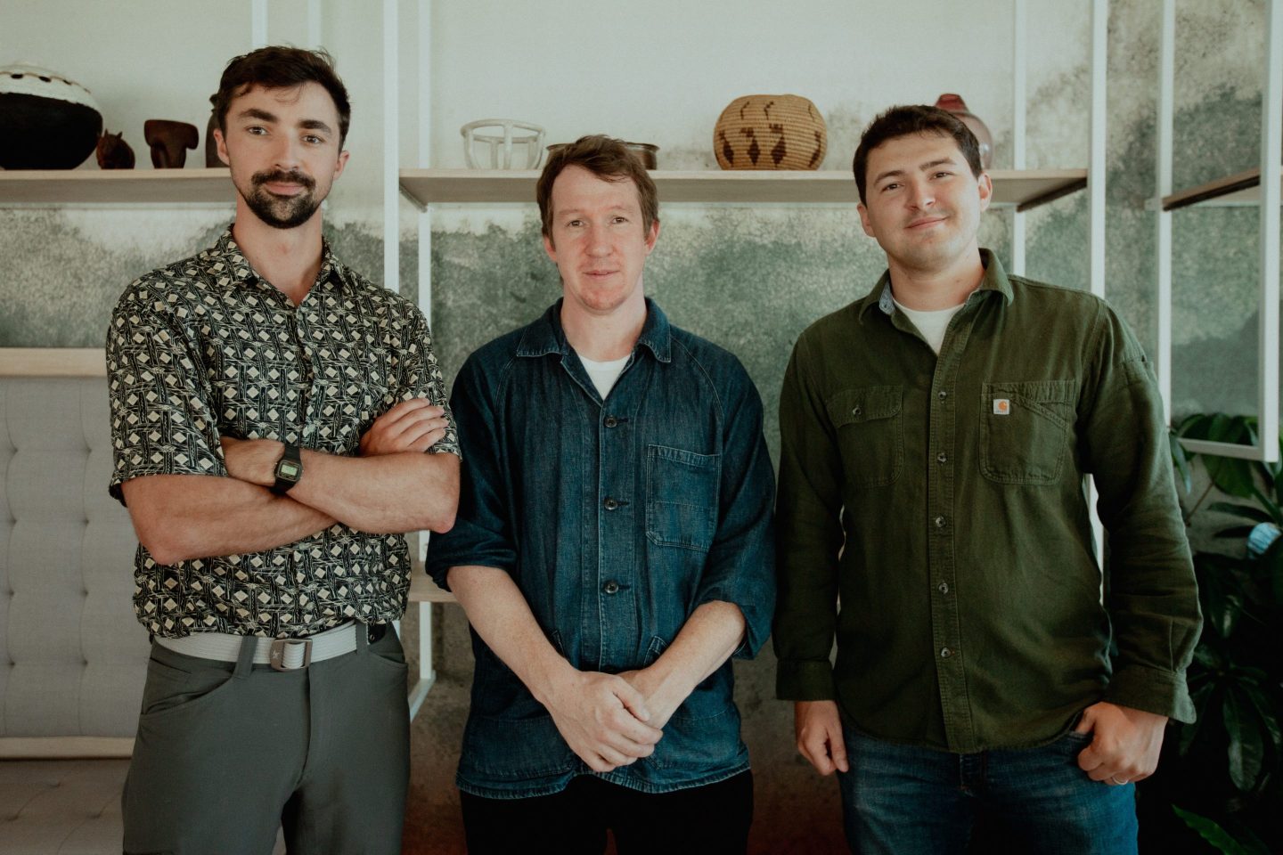 Logan Graham (left, arms crossed), Jack Clark (center), and Keane Lucas (right) — Anthropic Frontier Red Team, photographed for Fortune, September 2025.