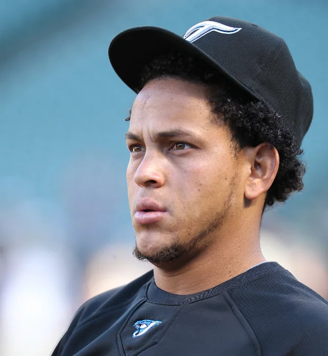 Baseball pitcher Henderson Álvarez in a blue cap, looking to his left