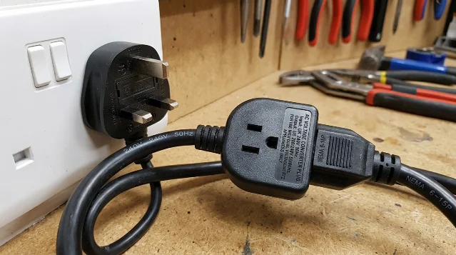 AI-generated image showing a male-to-male Type G power plug, an electrically lethal design