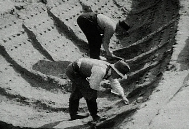 Basil Brown (foreground) in the ship impression at Sutton Hoo, summer 1939.