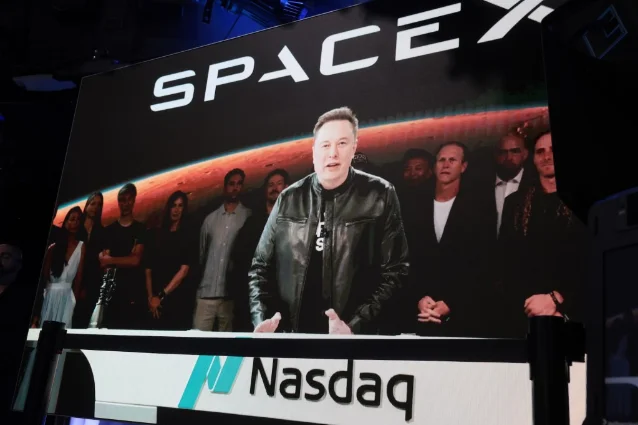 Elon Musk speaking via video at the Nasdaq Marketsite during SpaceX's June 12 IPO