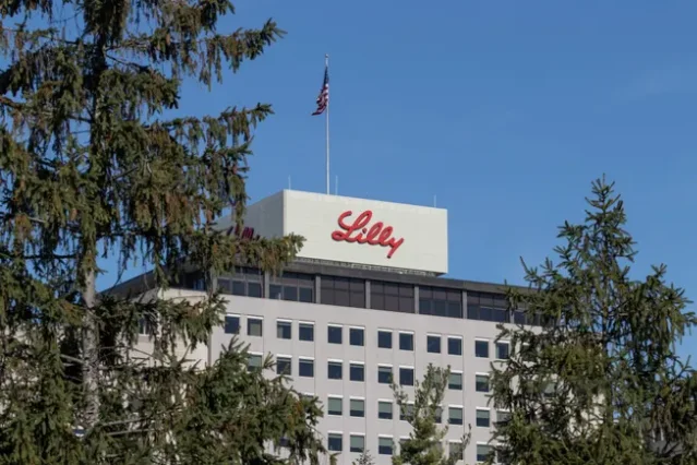 Eli Lilly headquarters building seen through pine trees