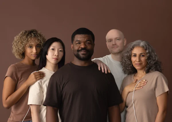 Five diverse patients with Nellcor finger sensors, representing the Monk Skin Tone range from light to dark skin, used in Medtronic Nell-EQ validation study