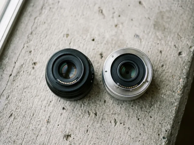 Fujifilm X-mount and Nikon Z lens on concrete surface with window light