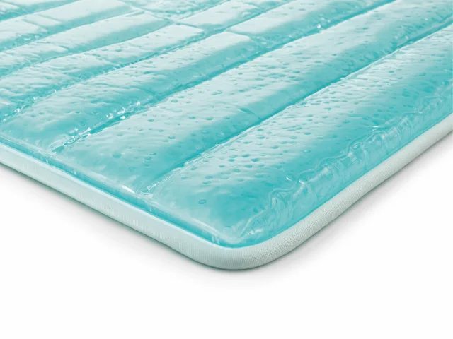 Teal gel dog cooling mat on white studio background