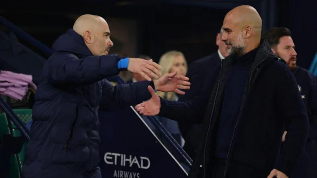 Pep Guardiola and Enzo Maresca embracing in front of Etihad Airways branding