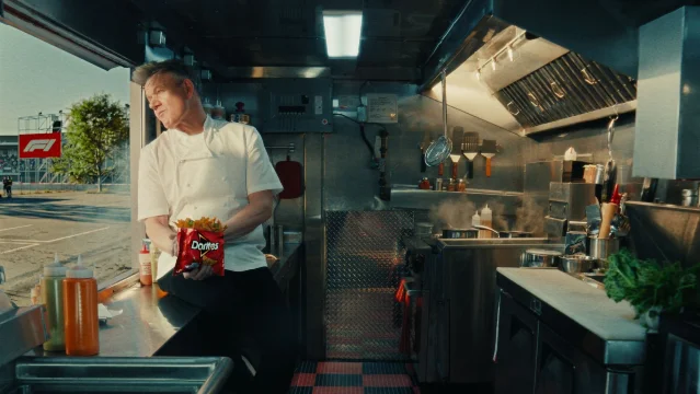 Gordon Ramsay 在 Doritos Loaded 餐车厨房内手持 Doritos 包装