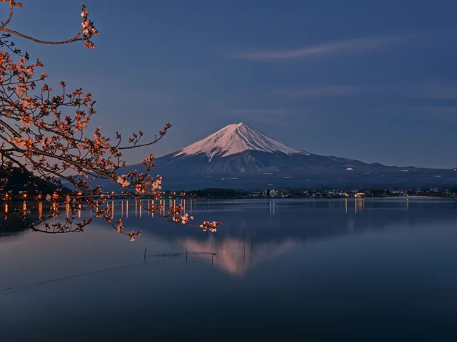 Mount Fuji reflected in the calm waters of Kawaguchiko Lake at sunrise