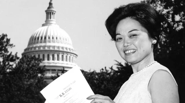Rep. Patsy Mink outside the U.S. Capitol holding a copy of H.R. 13196 — the Education Amendments of 1972 that included Title IX
