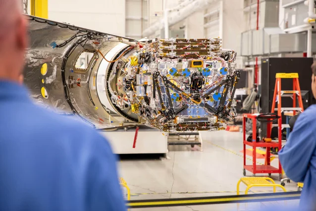 Katalyst's LINK robotic spacecraft being lowered into the Pegasus XL fairing at NASA Wallops Flight Facility, with engineers in cleanroom attire