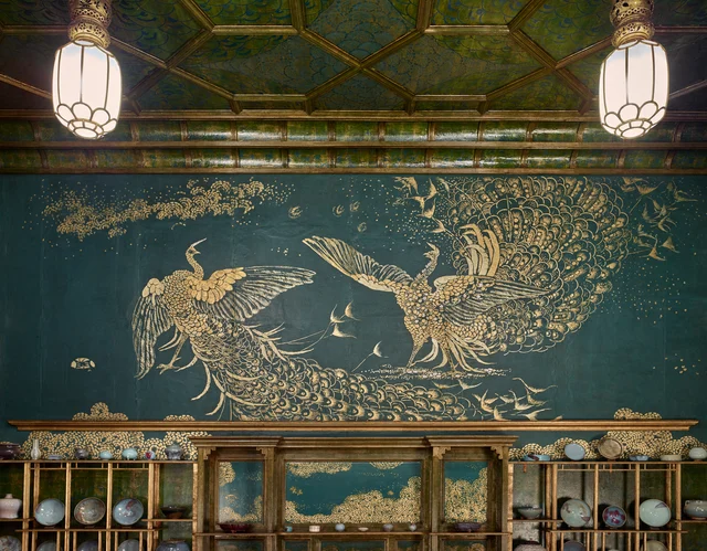 East wall with closed painted shutters and gilded shelves bearing Chinese porcelain