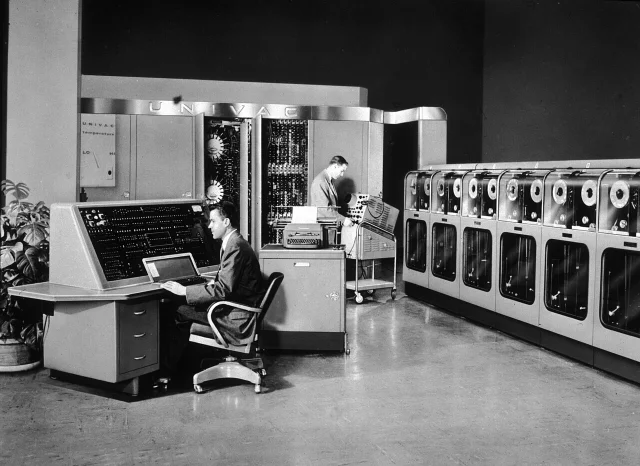 UNIVAC I at the US Census Bureau, early 1950s, showing two operators at the console with the UNISERVO magnetic tape drives visible at right