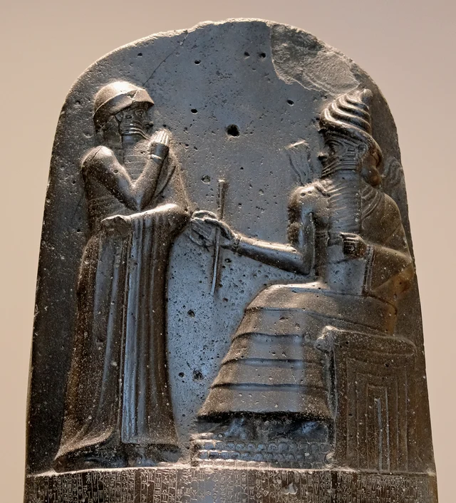 Close-up of the bas-relief at the stele's summit: Hammurabi stands before Shamash, who presents the rod and ring of royal authority
