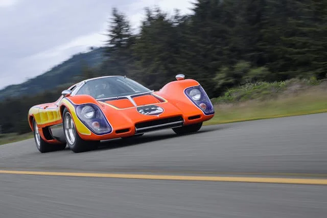 McLaren M6GT on a forest road