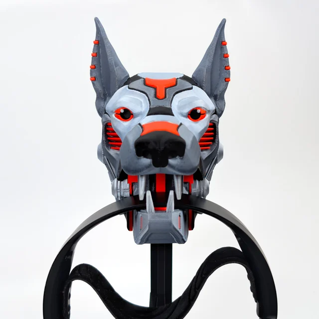 Cyber Dog silver-red colorway desktop stand, front view, gripping black headphones