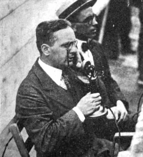 J. Andrew White speaks into a telephone at ringside during the Dempsey-Carpentier broadcast