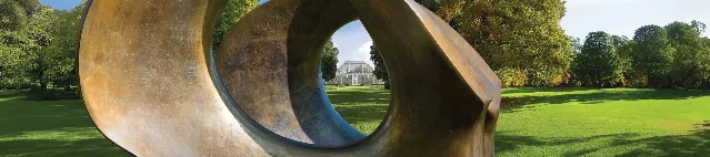 Henry Moore's Double Oval sculpture framing a view toward the Palm House at Kew Gardens