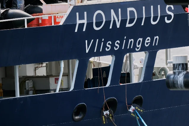 Crew in protective gear work on the MV Hondius at the Port of Rotterdam, May 18, 2026