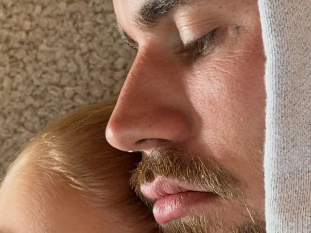 Justin Bieber cuddles his son in a close-up from his summer photo carousel