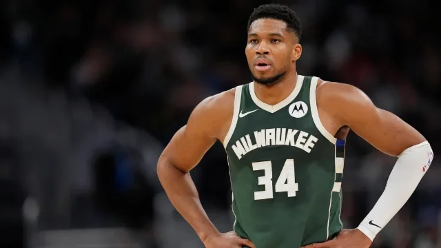 Giannis Antetokounmpo in Milwaukee Bucks #34 jersey, hands on hips