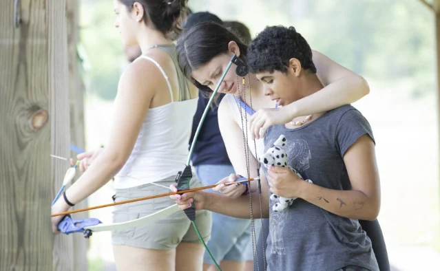 Ruby Odhner practices archery during Camp Cranium.
