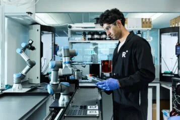 A Radical AI lab workflow with a robotic arm and alloy samples