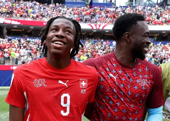 Johan Manzambi celebrates with Yvon Mvogo after Switzerland's late surge