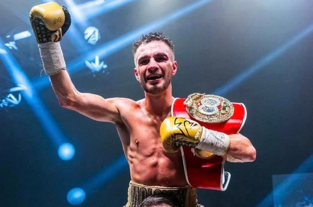 Andrew Moloney holds up the IBF super flyweight world championship belt after defeating Willibaldo Garcia in Japan